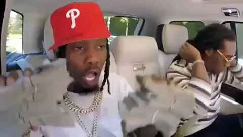 Offset of the Migos, holding handfuls of money in the backseat of Carpool Karaoke while Takeoff adjusts his hair.