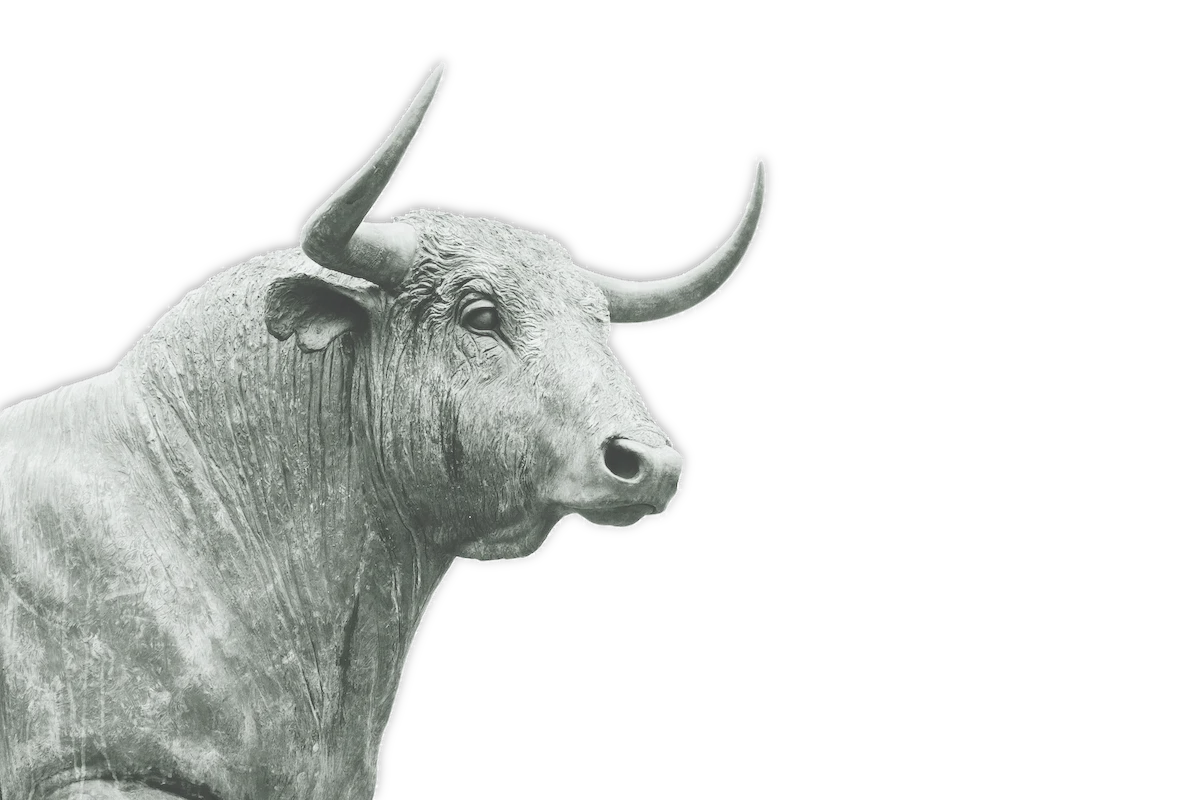 A grayscale photo of the head of a bull statue against a white background.