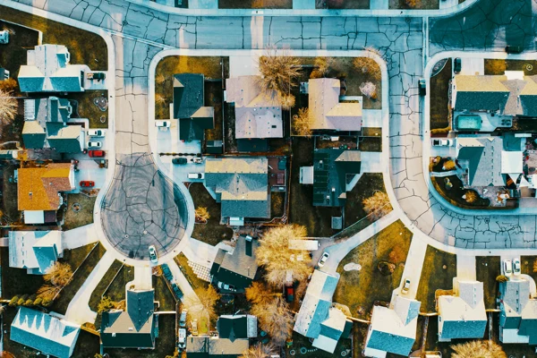 An aerial view of homes on a cul-de-sac and a nearby street.