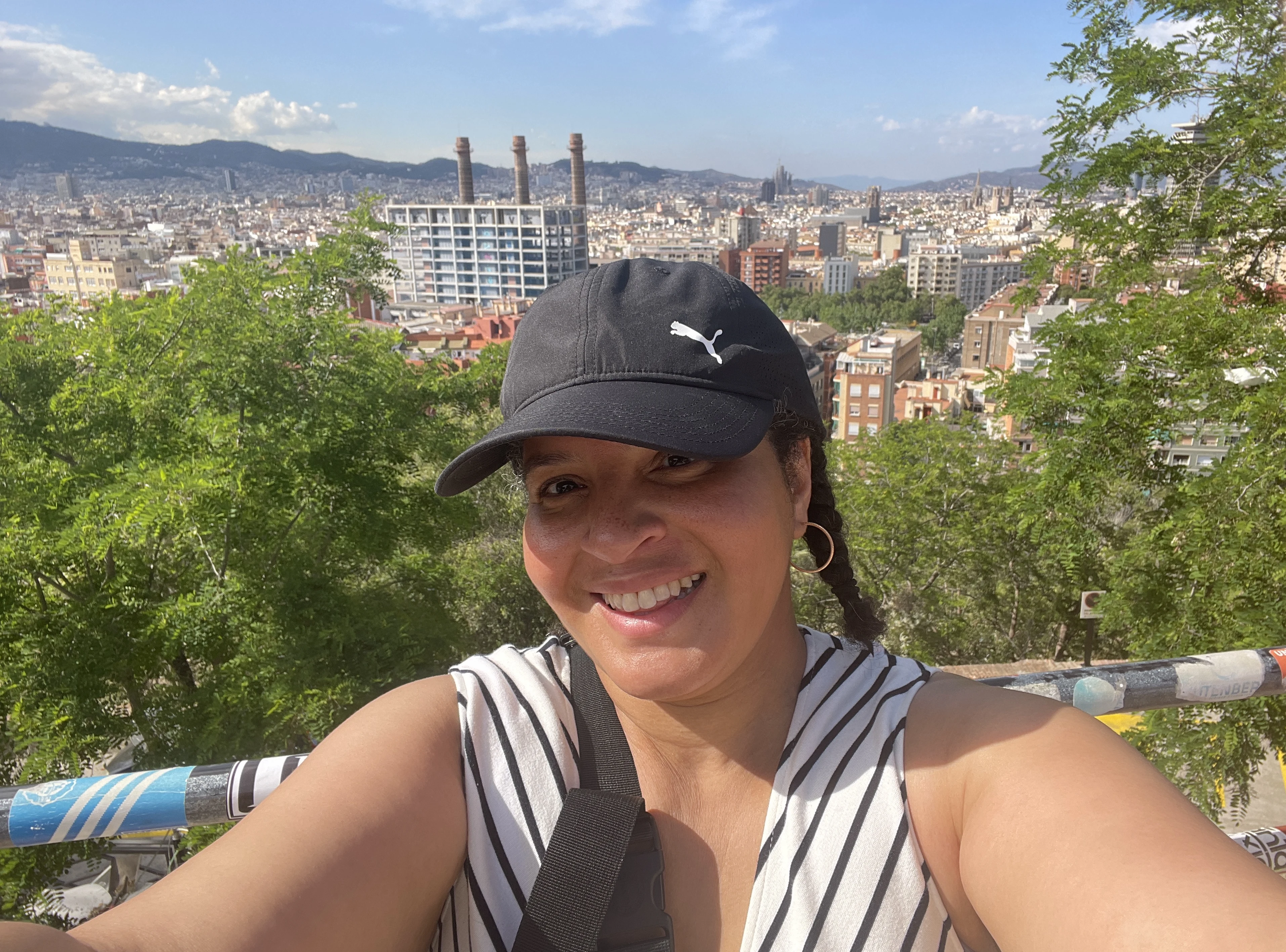 Tiffany in the Montjüic neighborhood of Barcelona. In the background are some native trees. Beyond the trees is the cityscape of Barcelona.